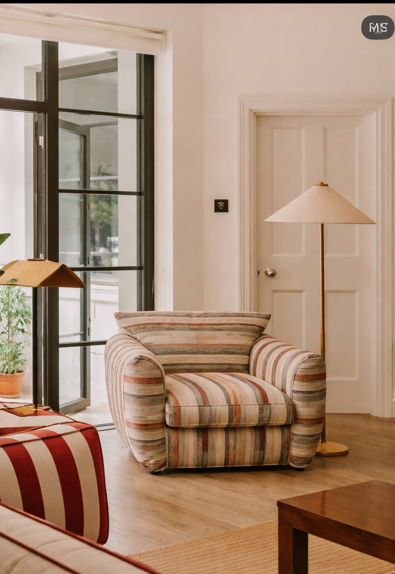 Striped armchair in a living room with a lamp and door in the background